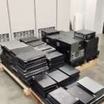 Stack of decommissioned IT equipment — servers and racks loaded on a pallet skid ready for secure removal