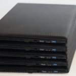stacked black notebook computers detailed